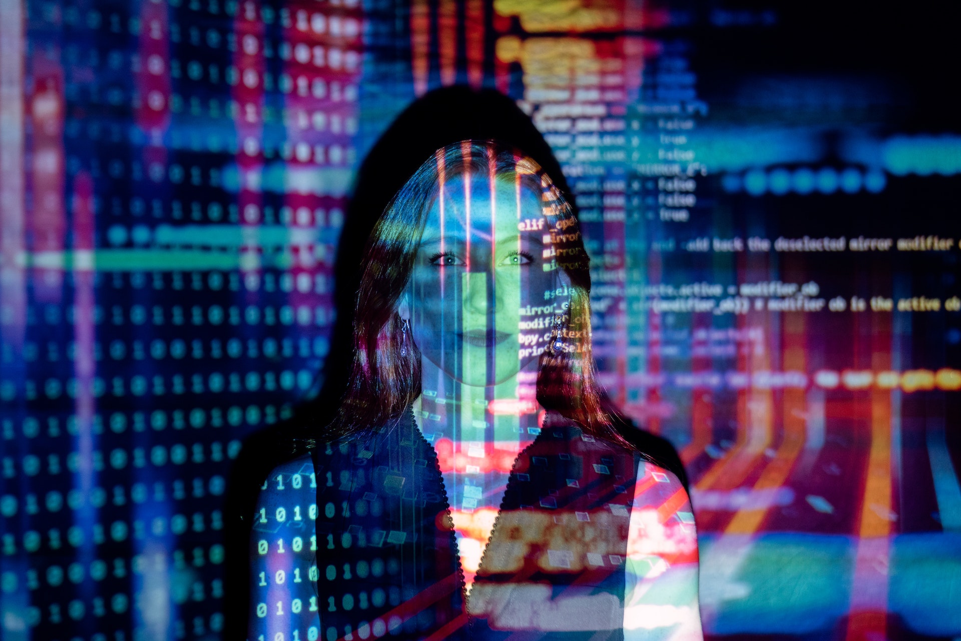 Code enhanced by AI projected onto a woman